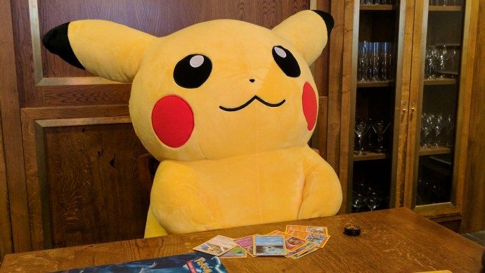 the_pokemon_trading_card_game _-_ stuffed_pikachu_with_cards