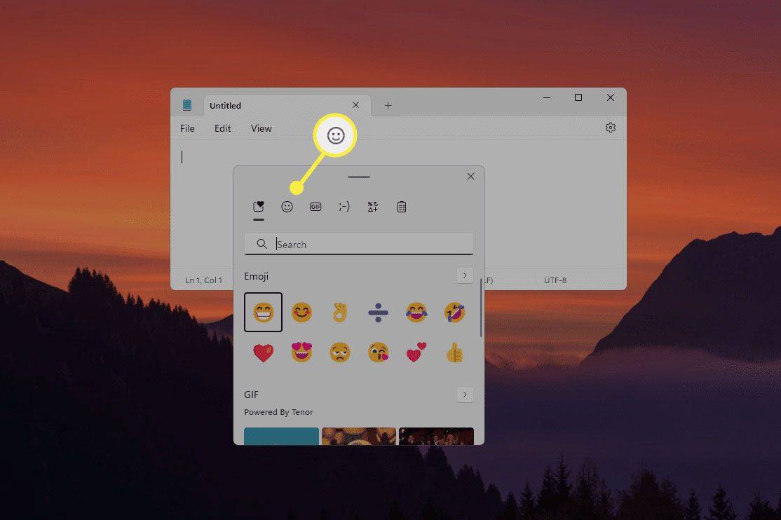 Tlačítko smajlíka zvýrazněné v horní části klávesnice emoji Windows 11.